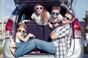 Happy family getting ready for road trip on a sunny day